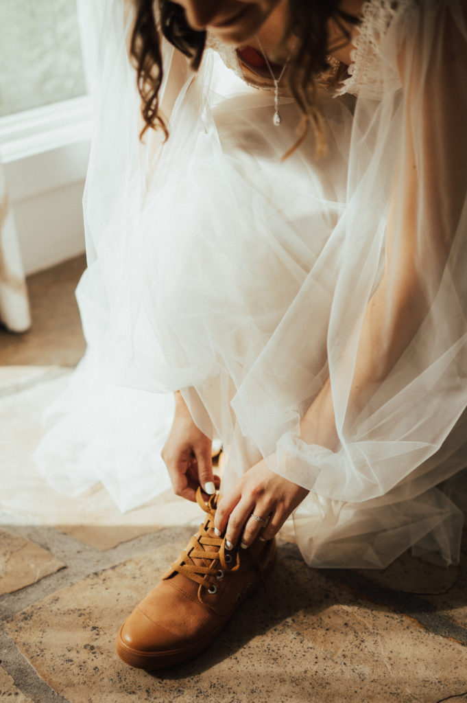 bride putting shoes on for Maroon Bells wedding