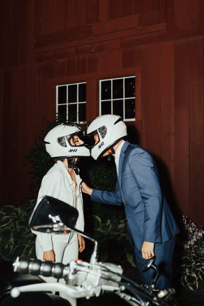 Unique Motorcycle Wedding Exit bride and groom with helmets
